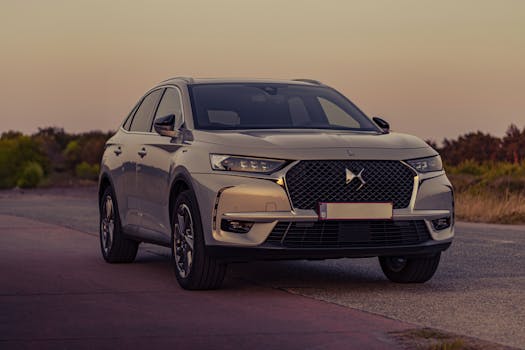 A sleek gray luxury SUV parked on a rural road at dusk, showcasing modern design.