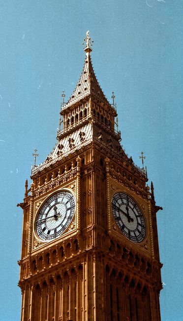 Stunning view of Big Ben in London, showcasing its Gothic architecture against a sunny sky.