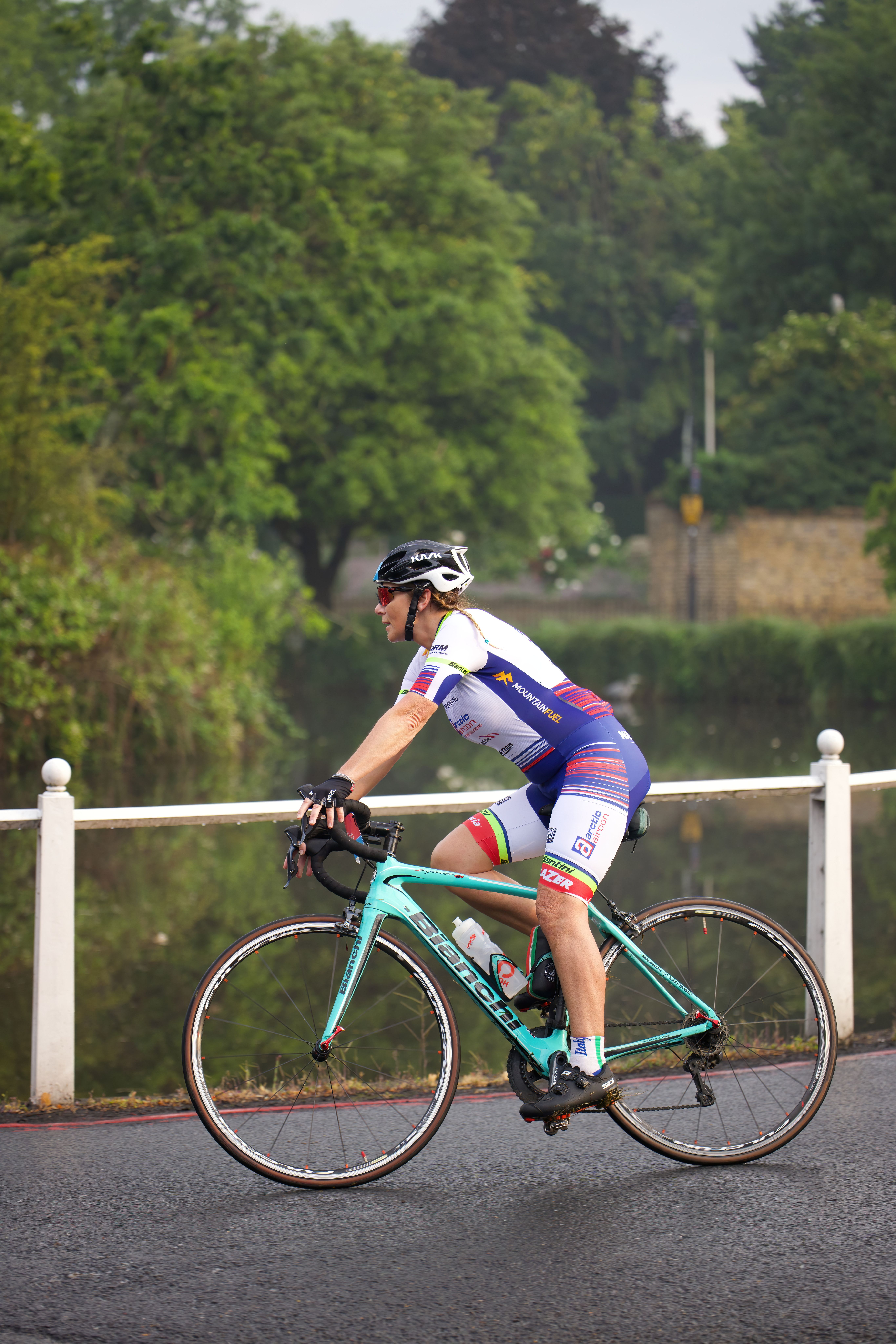 A person riding a bike on a road · Free Stock Photo