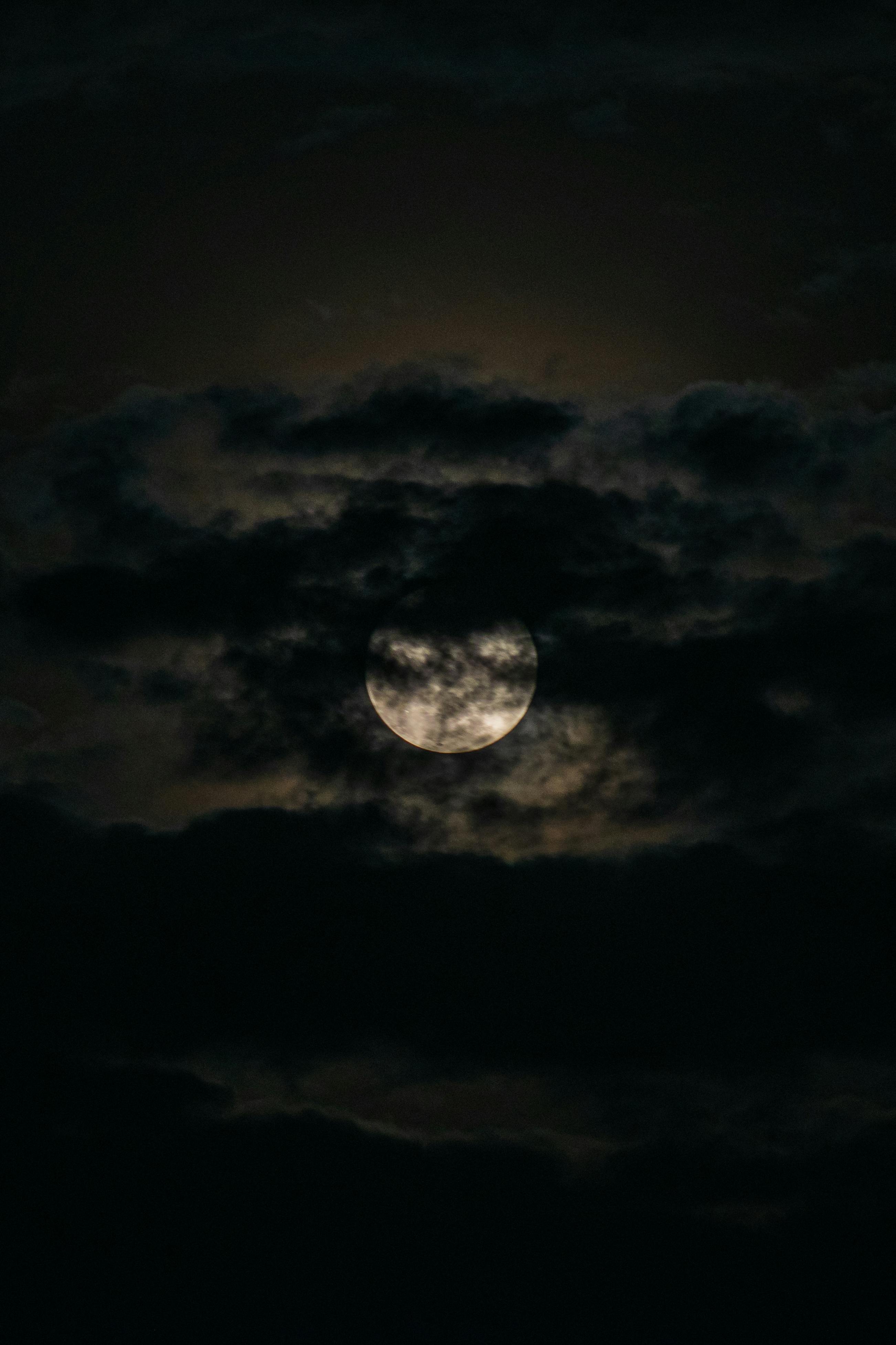 Close-up of a Full Moon behind Clouds · Free Stock Photo
