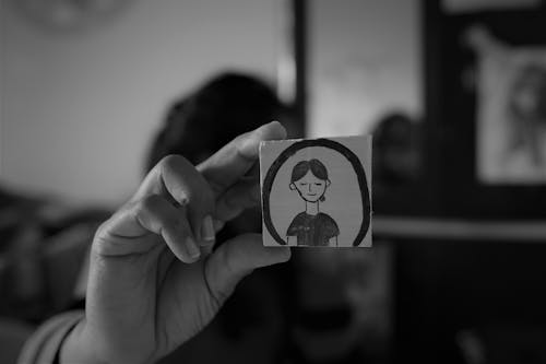 Woman Hand Holding Small Card with Drawing in Black and White