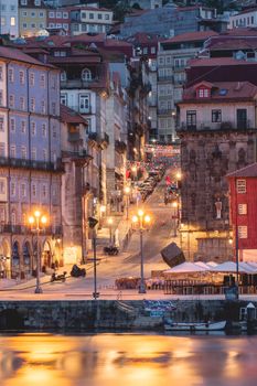 Beautiful nighttime cityscape of Porto, Portugal, showcasing illuminated streets and historic architecture.