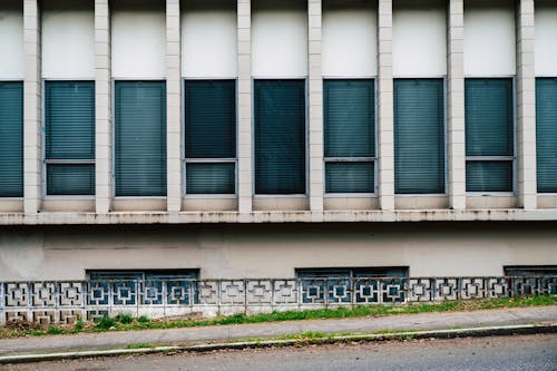 Dirty Facade of Abandoned Building Along Street