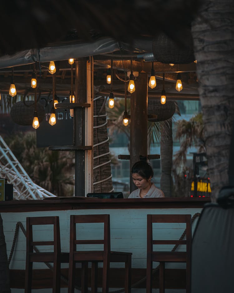 Employee Behind The Beach Bar Counter