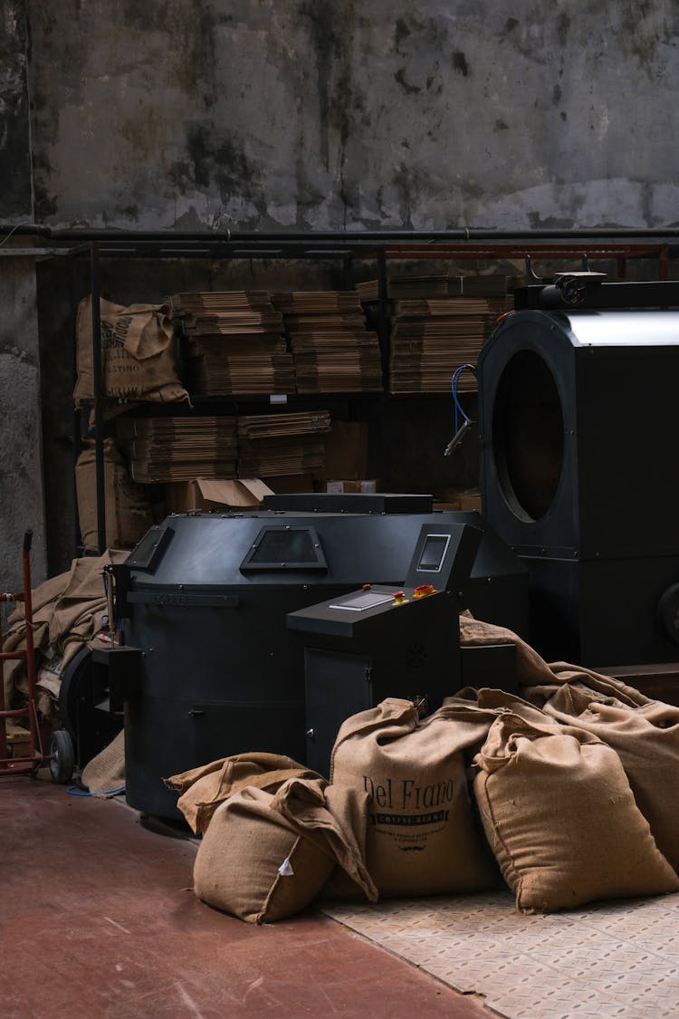 Burlap Sacks Around Industrial Coffee Roaster Machine