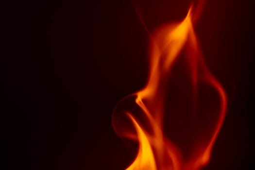 Vivid orange flames on a dark backdrop creating an abstract, artistic look.