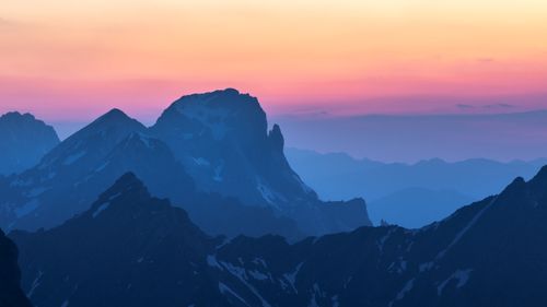 Free Breathtaking view of the Alpine mountains at sunset with vivid colors and layered peaks in the distance. Stock Photo