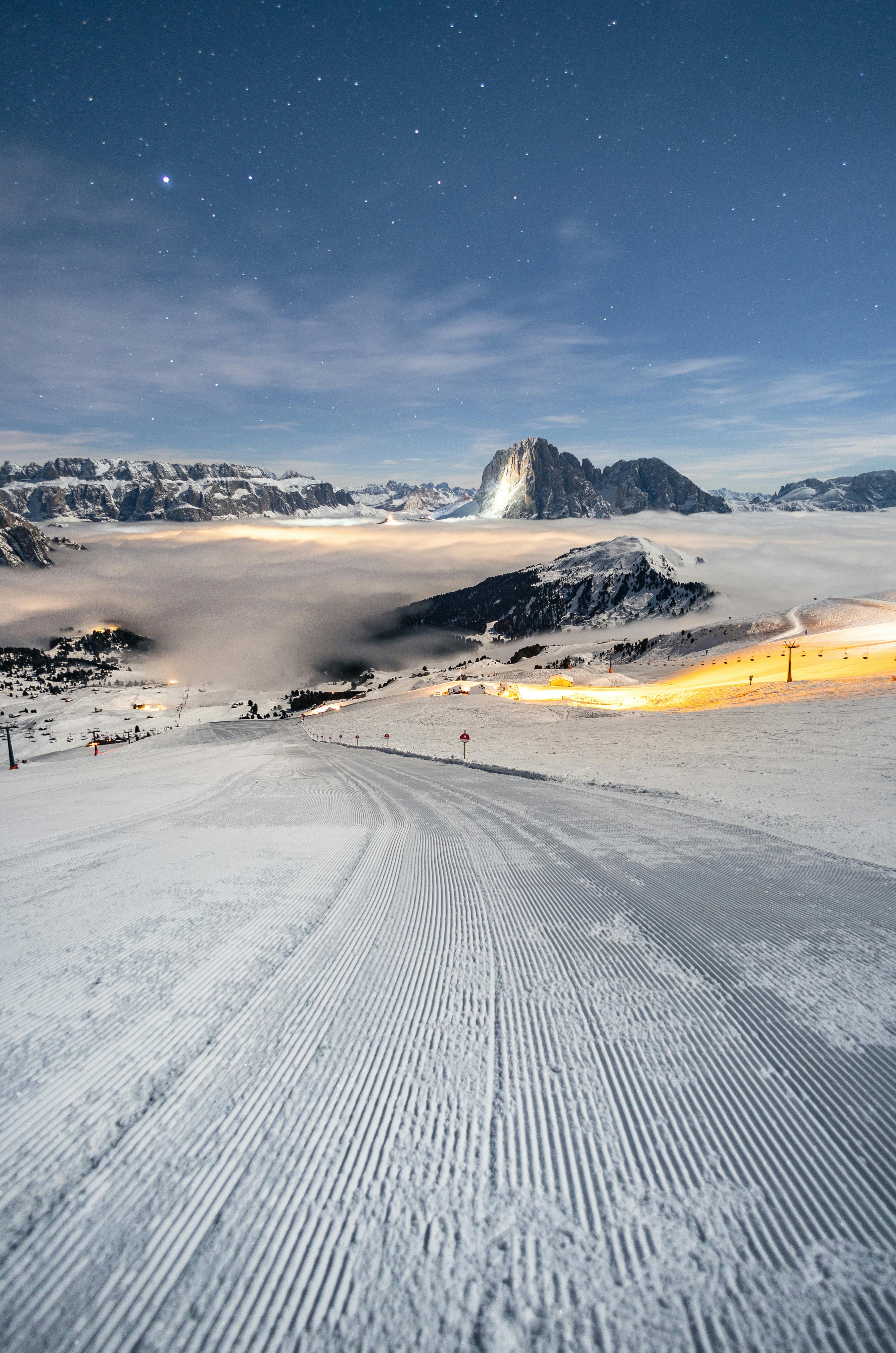 Prescription Goggle Inserts - Night view of a snow-covered ski slope under a starry sky in the Dolomites, Italy.