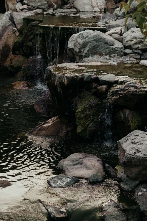 Free A tranquil waterfall cascading over stones in Краснодар, Россия, creating a serene atmosphere. Stock Photo