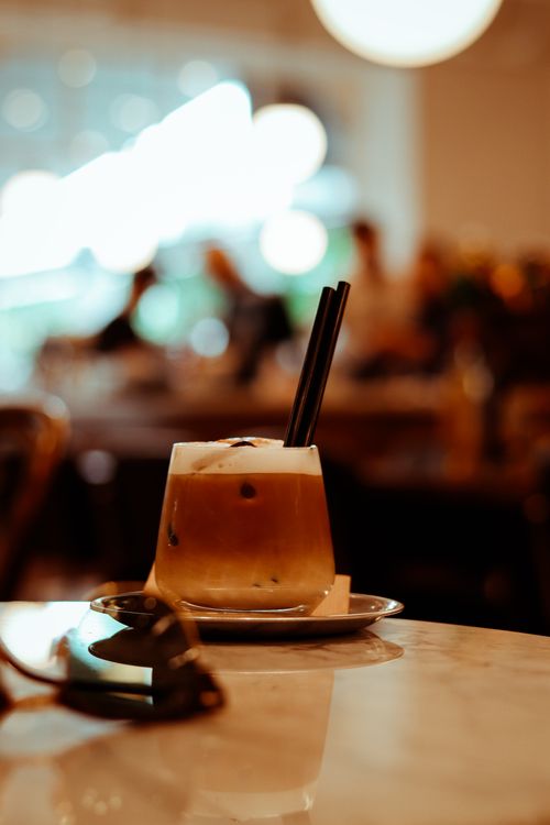 Free Close-up of a creamy iced coffee on a table in an Ankara café, featuring a relaxed atmosphere. Stock Photo
