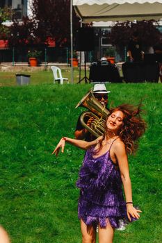 Woman dancing joyfully at an outdoor music festival in Ankara, Türkiye.