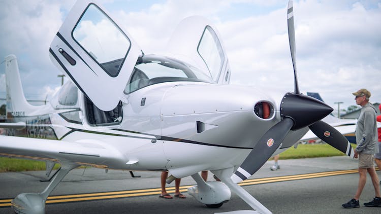 Photo Of A White Aircraft With Open Doors