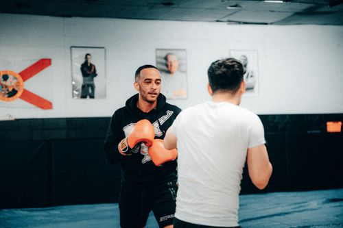 Free Boxing training session with two men practicing in a gym setting. Stock Photo