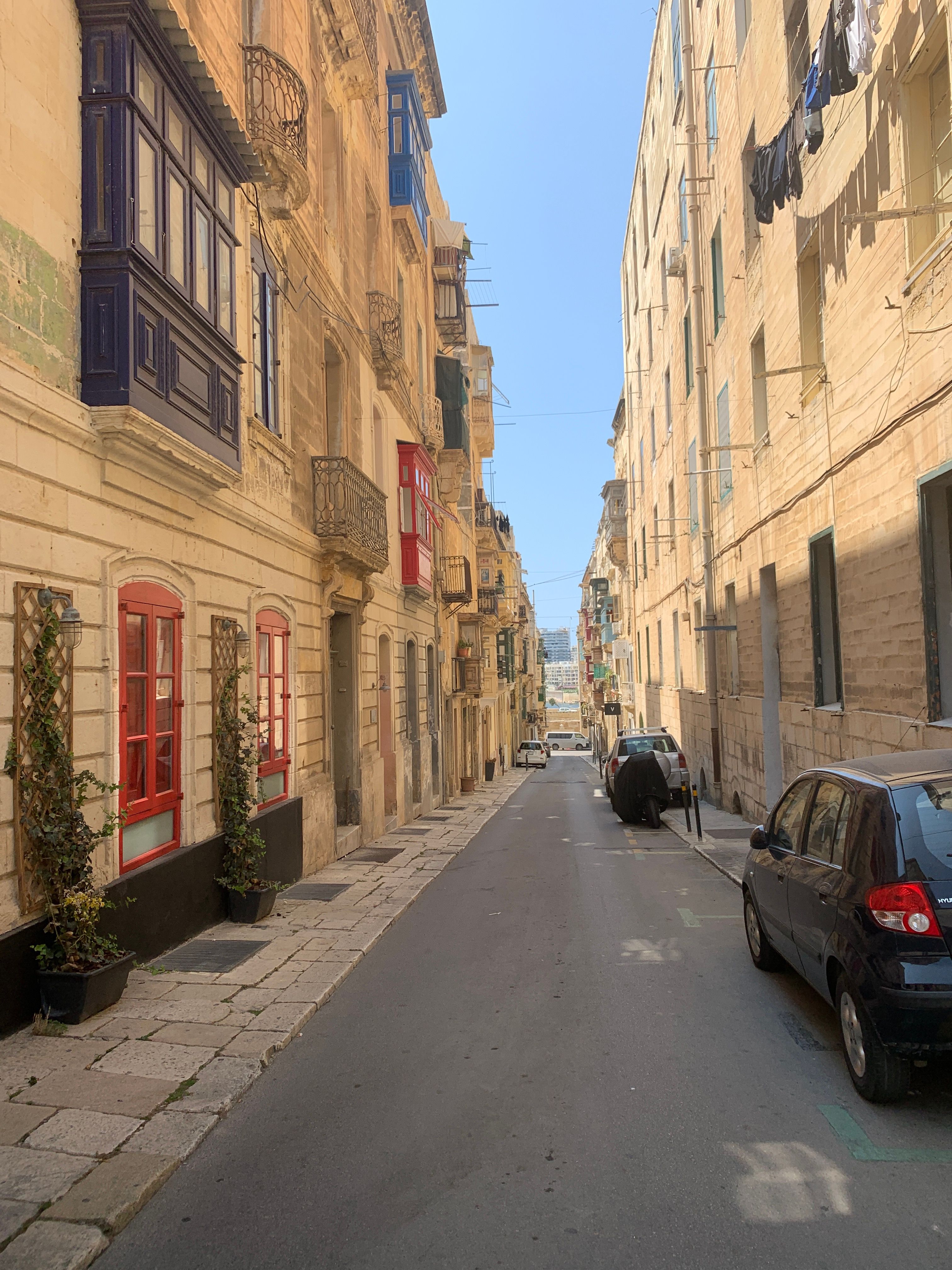 A Narrow Street between Traditional Buildings in Malta · Free Stock Photo