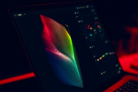 Close-up of vibrant digital art in red, green, and blue displayed on a monitor screen.