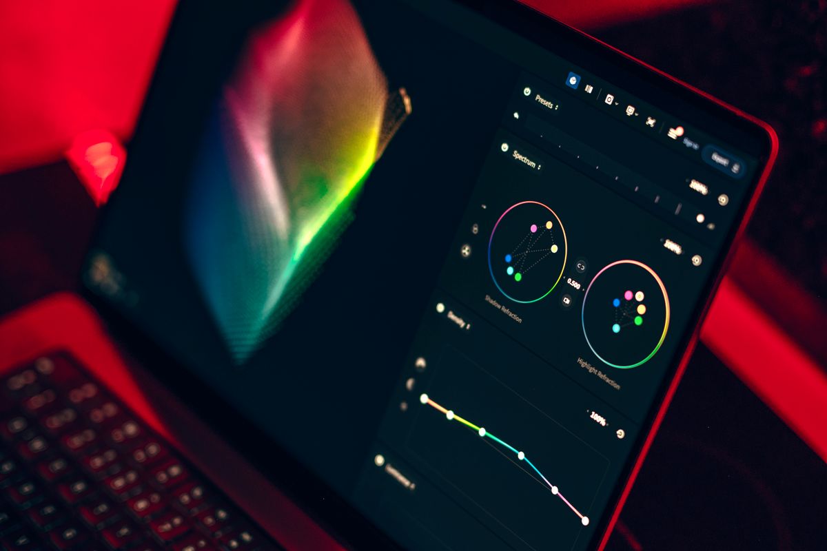 A laptop displaying a color grading dashboard