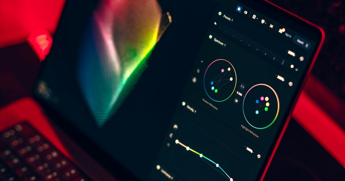 A laptop screen showing a colourful design dashboard during a UX audit.