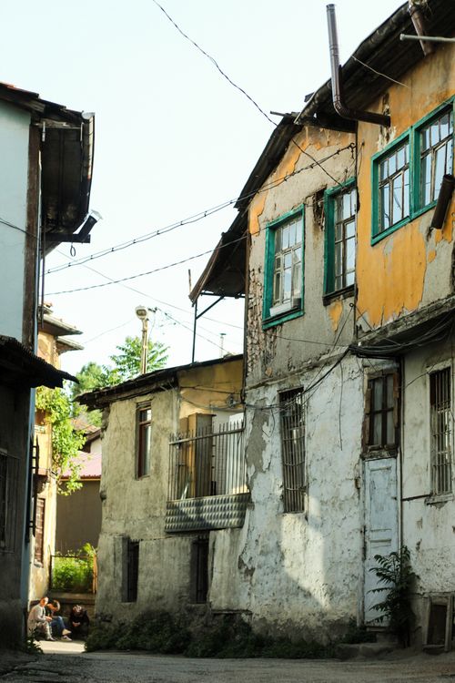 Free A vertical shot of decaying, abandoned houses in a neglected urban setting, showcasing architectural decay. Stock Photo