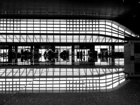 Captivating black and white airport terminal interior with reflections.