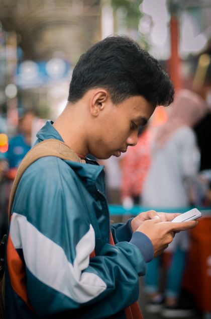 Man on a street using a phone