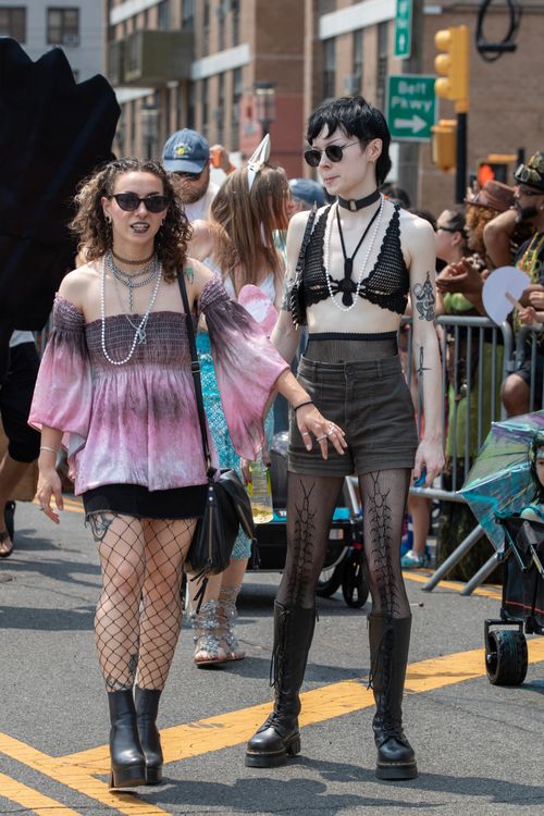 Free Two women in stylish and eccentric outfits at a lively street festival parade during the day. Stock Photo