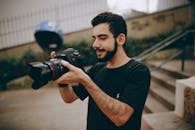 Photo of Man Taking Photo Using a Dslr Camera
