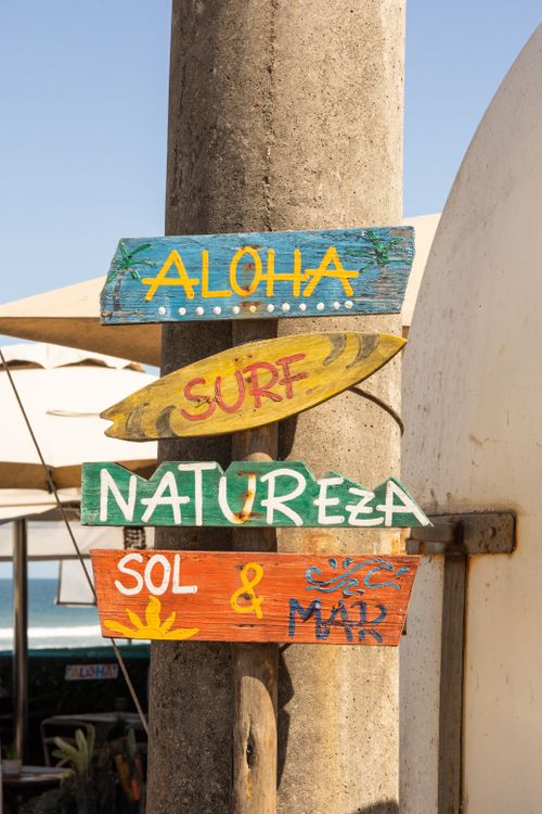 Free Vertical shot of vibrant seaside signs with Hawaiian theme, perfect for tropical inspiration. Stock Photo