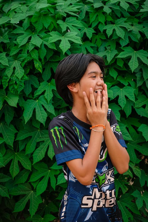 Laughing Boy against Lush Foliage