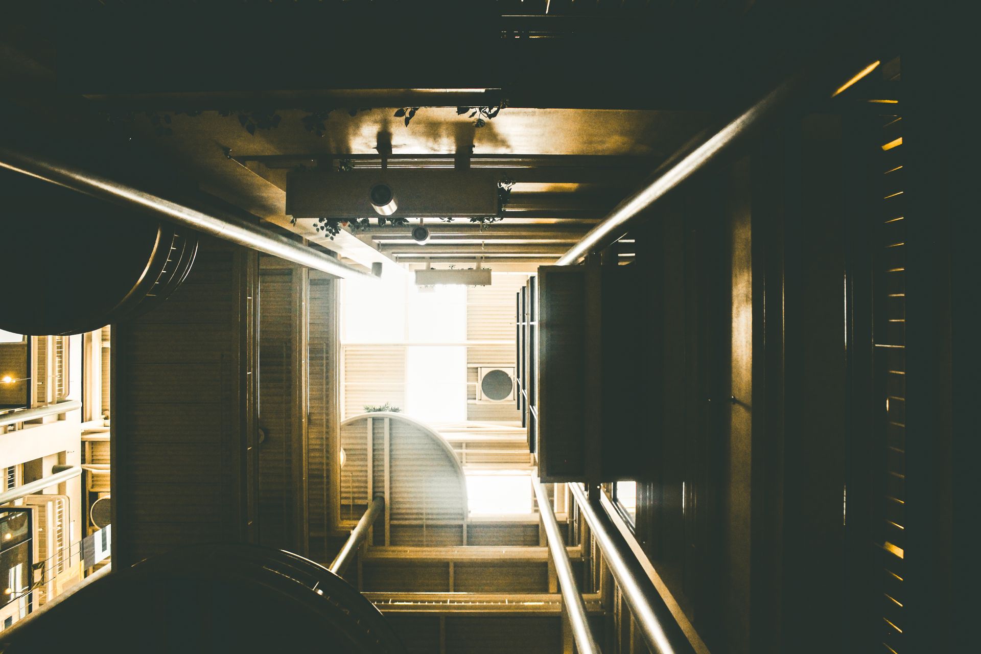 A captivating low-angle shot of an industrial-style building interior with a focus on light and perspective.
