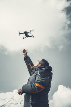 A man launches a drone against a cloudy winter sky in Puebla, Mexico.