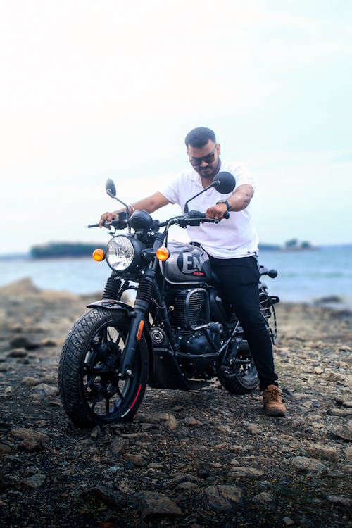 Man Sitting on a Motorcycle on a Beach 