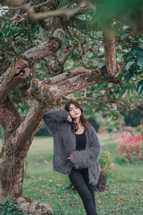 A Young Woman Wearing Fur Posing in Park