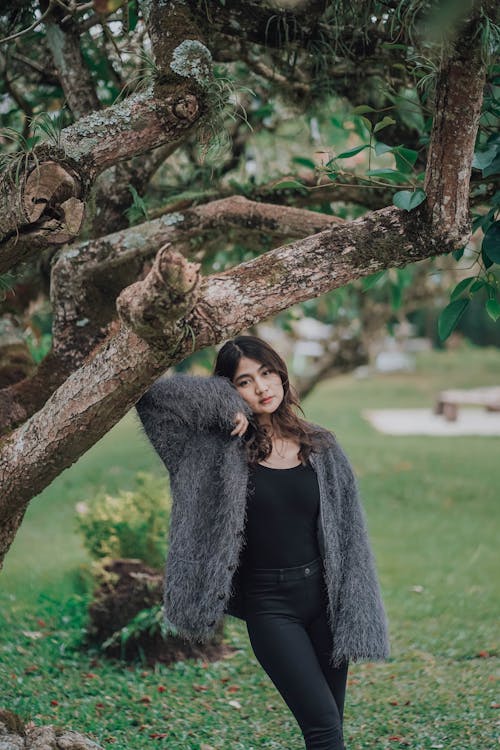 A Young Woman Wearing Fur Posing in Park
