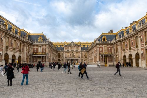 Free Visitors explore the historic Palace of Versailles, a UNESCO World Heritage Site in Paris, France. Stock Photo