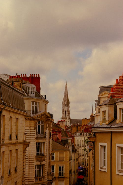 Clouds over Church Tower and Buildings in Town