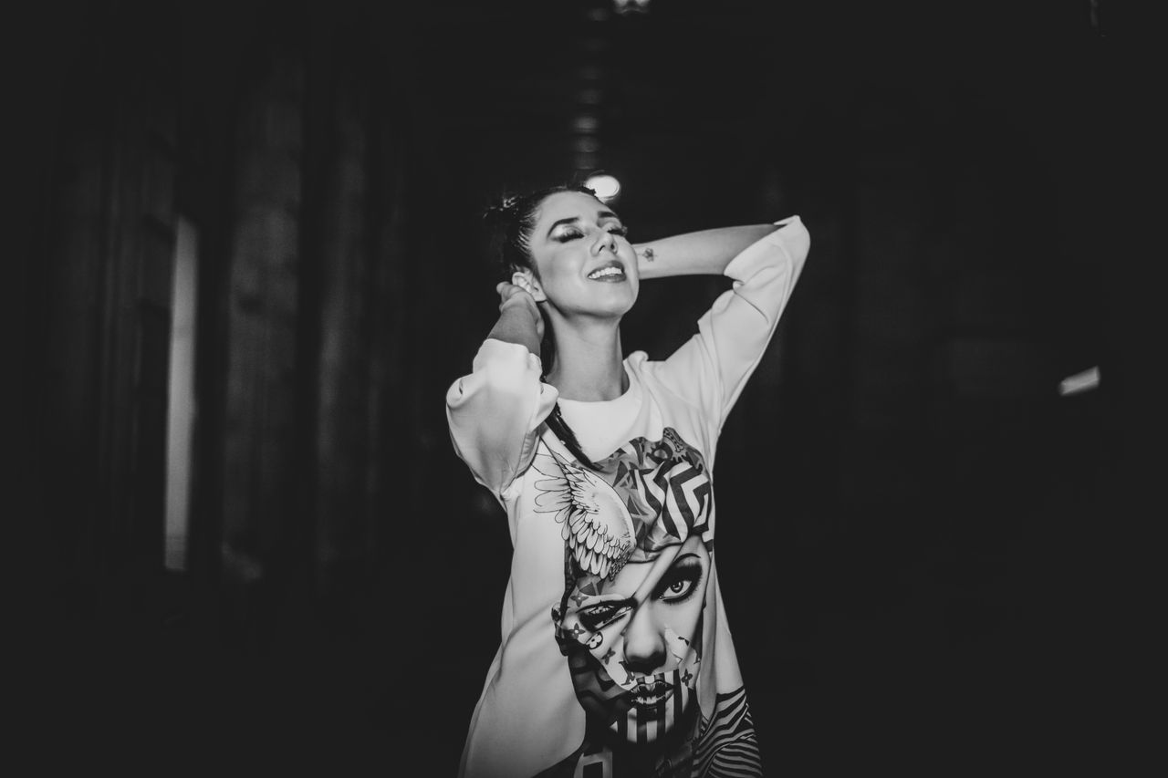 elegant black and white portrait of a woman posing confidently in an u