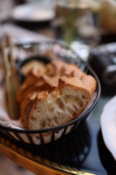 A close-up view of freshly sliced bread in a basket, showcasing detailed texture.