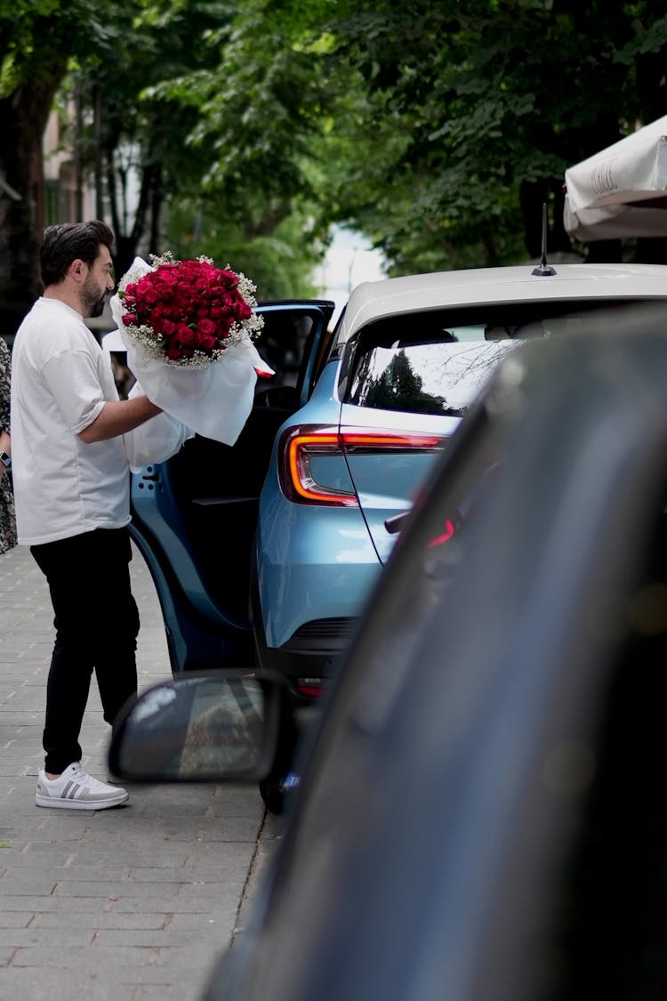 Man With Roses Bouquet Opening Car Door