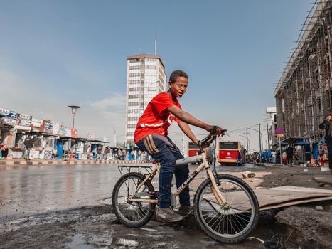 Boy on Bicycle on Bus Station