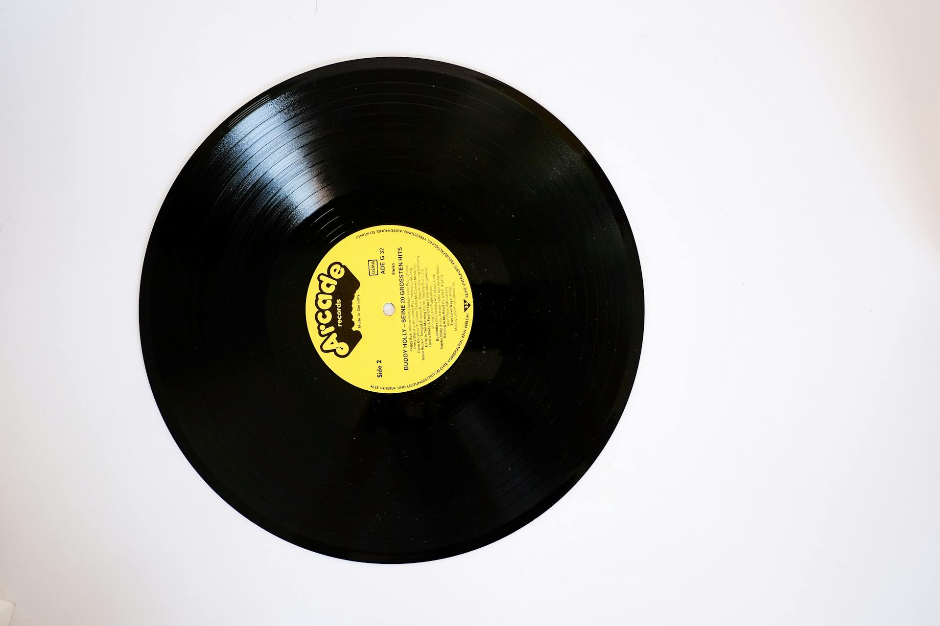 A vintage vinyl record with a yellow label on a plain white background, shot from above.