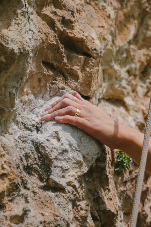 Close-up of Woman Touching a Rocky Wall 