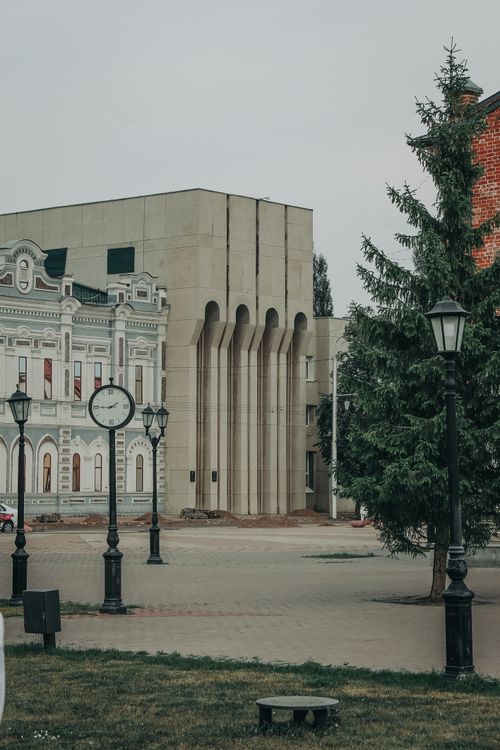 Free A serene urban square featuring historic buildings and a classic street clock. Stock Photo