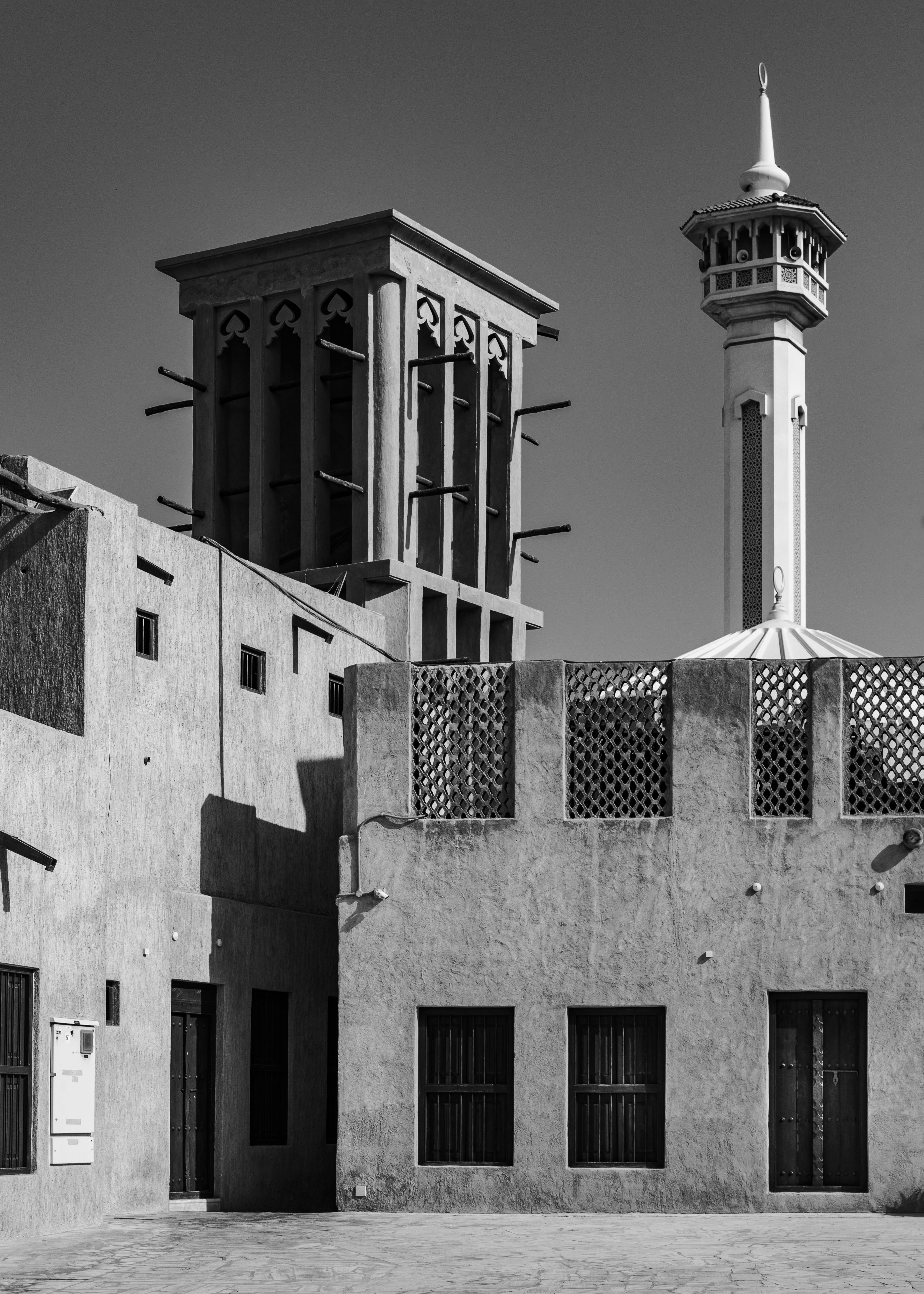 Black and white photo showcasing traditional architecture in Dubai's historic district.