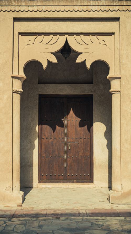Free Elegant wooden door with Islamic architectural details in Dubai, UAE. Stock Photo