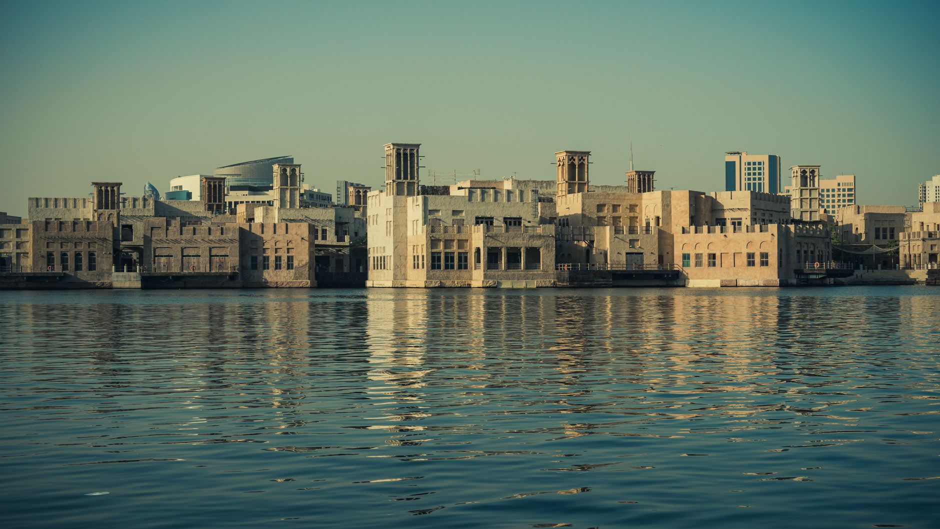 Scenic view of modern architecture reflecting on the Dubai Creek waters, showcasing Dubai's waterfront skyline.. Photo by Walid Ahmad on Pexels