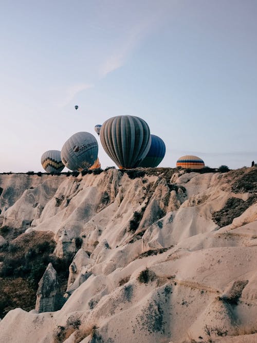 Hot Air Balloons behind Rock Formations