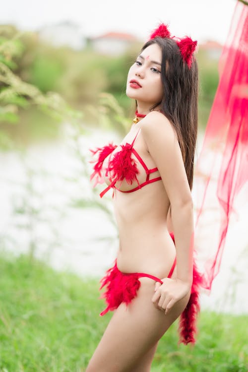 Young Woman in Red Lingerie Posing Outside 