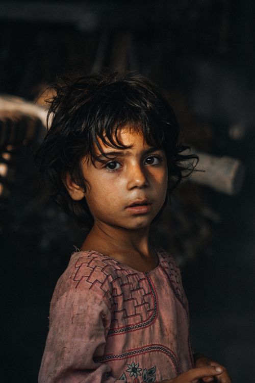 Free A captivating portrait of a child with dark, wavy hair, showcasing innocence and emotion. Stock Photo