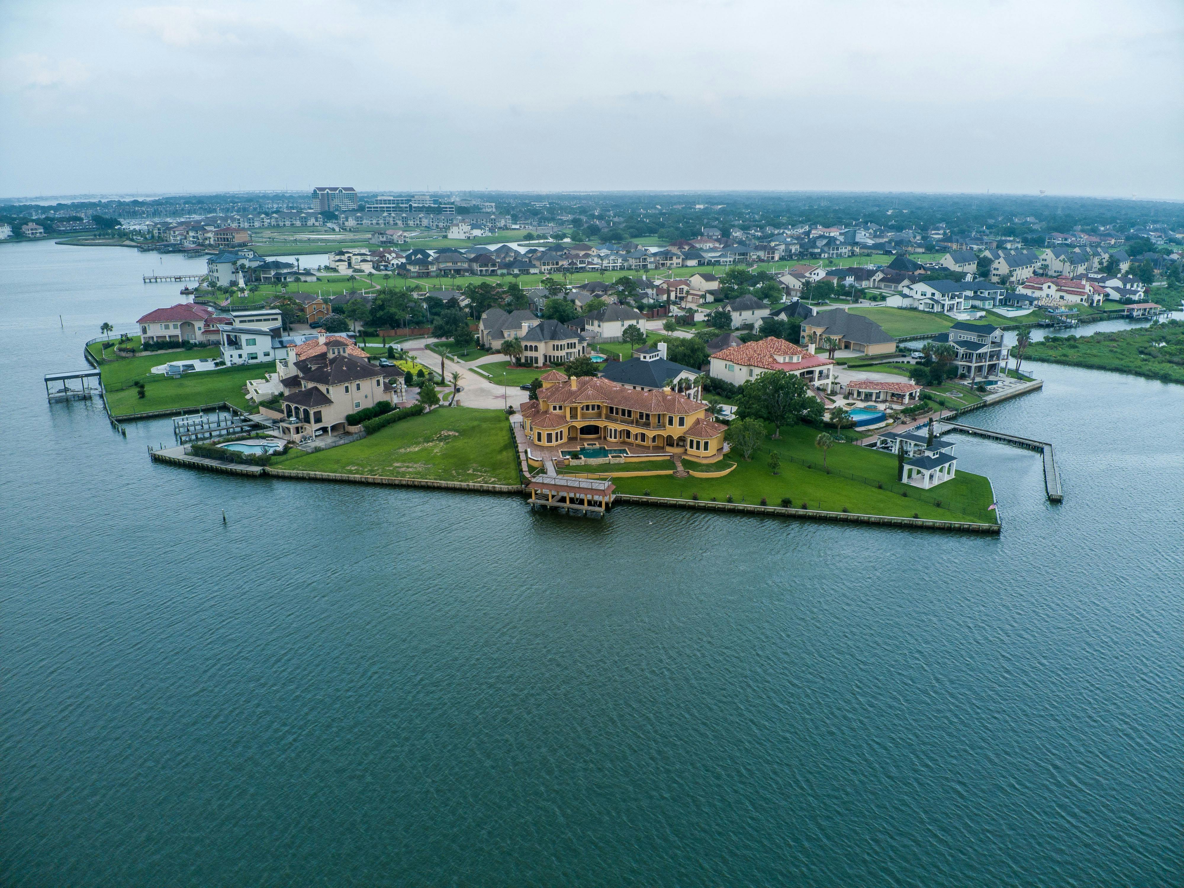 an aerial view of a large house on the water