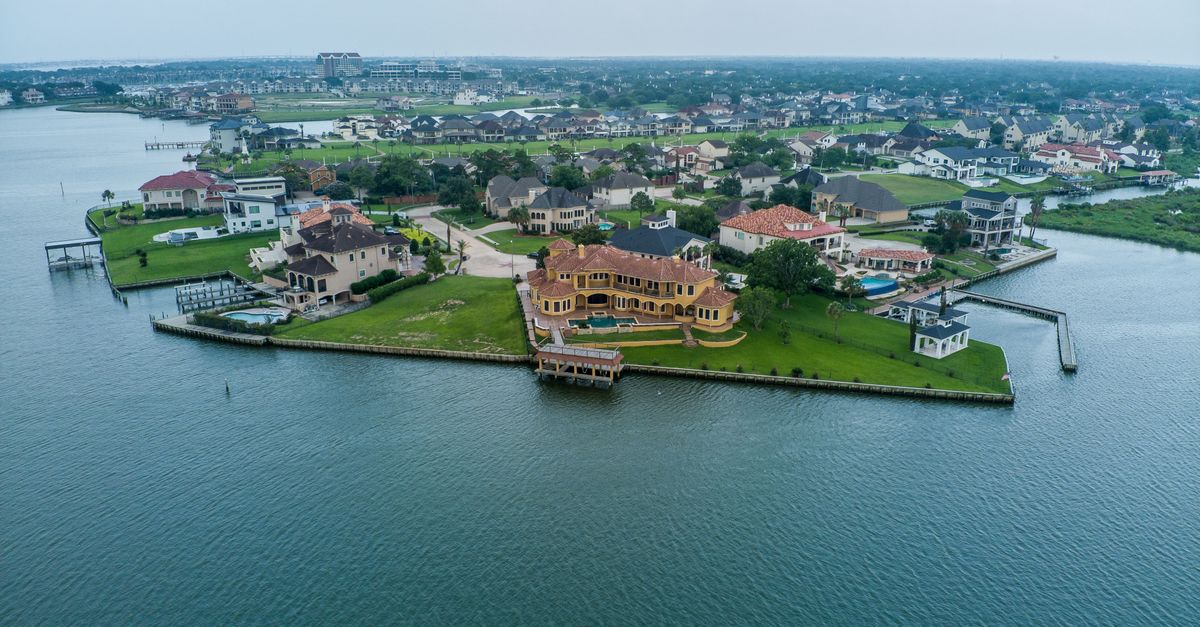 Stunning aerial shot of luxury homes by the water in Houston, Texas.